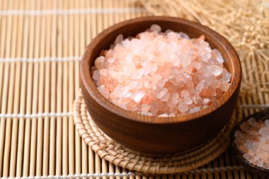 Organic Himalayan pink salt in wooden bowl, Healthy food ingredient