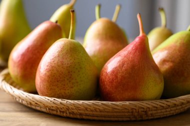 Fresh pear fruit in natural basket, Close up