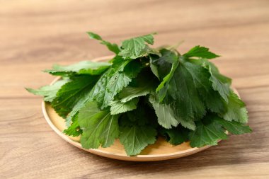 White mugwort on wooden plate, Organic Asian vegetables and herbal medicine
