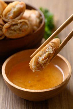 Kabak, havuç ve cam erişteyle doldurulmuş Asya usulü kızarmış börek çubuklarla sosla yenir.