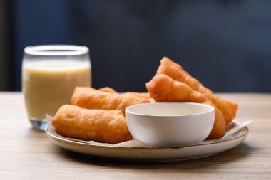 Asian deep fried dough eaten with soy milk and condensed milk, Thai style breakfast clipart