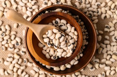 Siyah gözlü bezelye ya da ahşap kasede bezelye kepçeli, yemek malzemeli, üst manzara