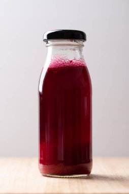 Tahta tahtada şişede taze pancar suyu, sağlıklı bir içecek.