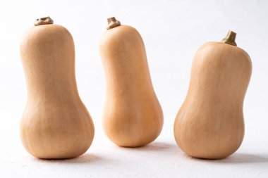 Beyaz arka planda taze tereyağlı balkabağı, sonbahar mevsiminde sebze, yiyecek malzemesi.