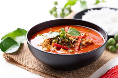 Domuz etli Tayland körisi ve beyaz arka planda malzemeli pilav.