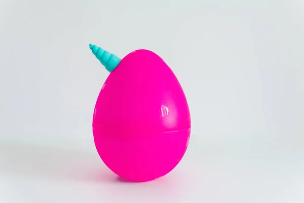 Big pink unicorn egg toy on the white background. Popular plastic toy with surprise inside.