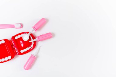 Flat lay of children's dentist set. White background. Medical, stomatology, dental, oral care and healthcare concept. Copy space.