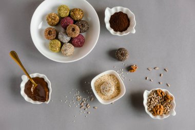 Sağlıklı el yapımı tatlılar, toplar, doğal malzemelerden yapılan şekerler. Fındık, kakao, tohum, hindistan cevizi ve böğürtlenden yapılmış enerji tatlısı. Şekersiz. Vejetaryen organik yiyecekler. Gri arkaplan