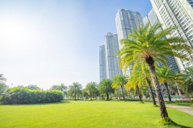 Morning view with sunny and green trees at Landmark 81 - it is a super tall skyscraper with development buildings along Saigon river in Ho Chi Minh city, Vietnam. Business, travel concept.