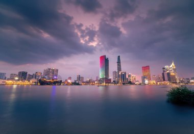 Ho Chi Minh city, Vietnam - 02 Sep 2022: view of Bitexco and IFC One Tower, buildings, roads and Saigon river in Ho Chi Minh city - Laser and lighting show displayed. Travel and landscape concept.