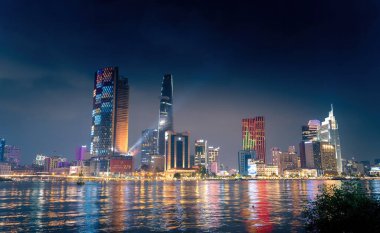 Ho Chi Minh city, Vietnam - 02 Sep 2022: view of Bitexco and IFC One Tower, buildings, roads and Saigon river in Ho Chi Minh city - Laser and lighting show displayed. Travel and landscape concept.