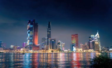 Ho Chi Minh city, Vietnam - 02 Sep 2022: view of Bitexco and IFC One Tower, buildings, roads and Saigon river in Ho Chi Minh city - Laser and lighting show displayed. Travel and landscape concept.