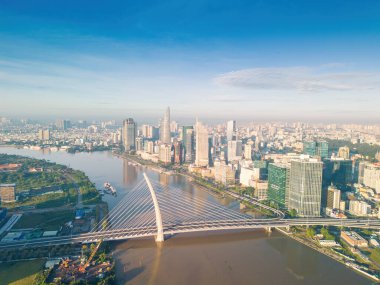 Ho Chi Minh city, Vietnam - 27 Aug 2022: Aerial view of Ho Chi Minh City skyline and skyscrapers on Saigon river, center of heart business at downtown. Morning view. Far away is Landmark 81 skyscraper