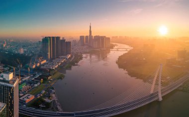 Ho Chi Minh city, Vietnam - 27 Aug 2022: Aerial view of Ho Chi Minh City skyline and skyscrapers on Saigon river, center of heart business at downtown. Morning view. Far away is Landmark 81 skyscraper