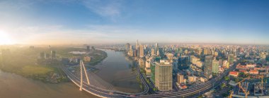 Ho Chi Minh city, Vietnam - 27 Aug 2022: Aerial view of Ho Chi Minh City skyline and skyscrapers on Saigon river, center of heart business at downtown. Morning view. Far away is Landmark 81 skyscraper