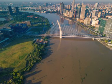 Ho Chi Minh city, Vietnam - 27 Aug 2022: Aerial view of Ho Chi Minh City skyline and skyscrapers on Saigon river, center of heart business at downtown. Morning view. Far away is Landmark 81 skyscraper