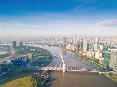 Ho Chi Minh city, Vietnam - 27 Aug 2022: Aerial view of Ho Chi Minh City skyline and skyscrapers on Saigon river, center of heart business at downtown. Morning view. Far away is Landmark 81 skyscraper