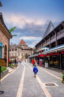 Da Nang, Vietnam - 12 Aug 2022: Many tourists on European style streets in Ba Na Hills Mountain Resort with amusement rides, attractions, restaurants.The famous tourist destination in Da Nang
