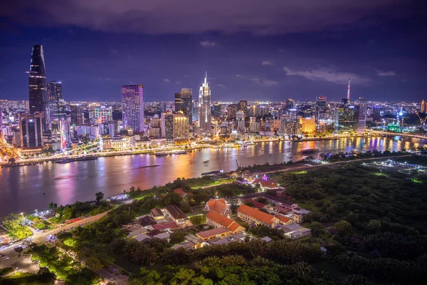 Aerial view of Ho Chi Minh City skyline and the Saigon River at sunset. Amazing colorful view of skyscraper and other modern buildings at downtown. It is a popular tourist destination of Vietnam.