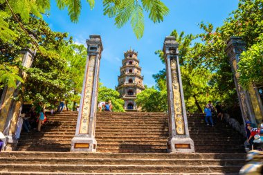 Hue city, Vietnam - 14 Aug 2022: view of The Thien Mu Pagoda with many tourists. It is one of the ancient pagoda in Hue city. Near the Perfume River in Vietnam's historic city of Hue.
