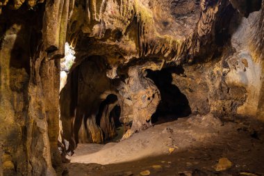 step stone staircase in the ruins of the ancient cave city. Underground river flowing in rock tunnel. Dark creepy abandoned underground chalky cave. Selective focus