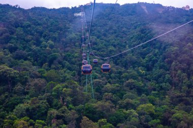 Cable cabs are running on high wire at Bana Hills in Danang, Vietnam. Bana Hills is interesting tourist new places to visit in Da Nang city, Vietnam. Travel concept.