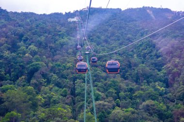 Cable cabs are running on high wire at Bana Hills in Danang, Vietnam. Bana Hills is interesting tourist new places to visit in Da Nang city, Vietnam. Travel concept.