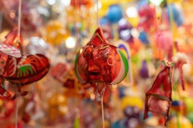 Decorated colorful lanterns hanging on a stand in the streets of Cholon in Ho Chi Minh City, Vietnam during Mid Autumn Festival. Chinese language in photos mean money and happiness. Selective focus.