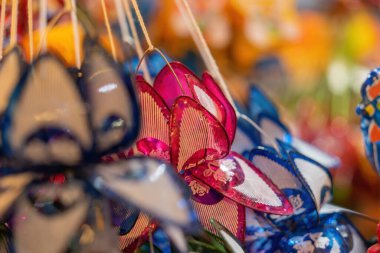 Decorated colorful lanterns hanging on a stand in the streets of Cholon in Ho Chi Minh City, Vietnam during Mid Autumn Festival. Chinese language in photos mean money and happiness. Selective focus.