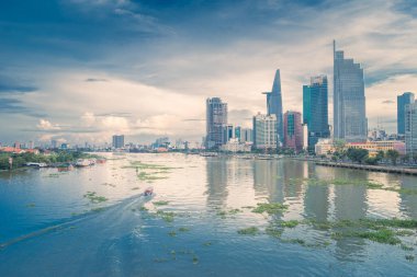 Ho Chi Minh city, Vietnam - 27 June 2022: Aerial view of Bitexco Tower, buildings, roads, Thu Thiem 2 bridge and Saigon river in Ho Chi Minh city - Far away is Landmark 81 skyscraper. Travel concept.