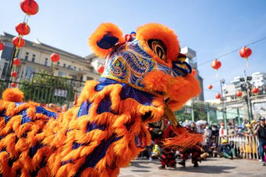 Dragon and lion dance show in chinese new year festival (Tet festival ), lion Dance - dragon and lion dance street performances in Vietnam. Holidays and celebrations concept. Selective focus.