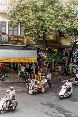 Hanoi, Vietnam - 08 Mayıs 2023: İnsanlar, satıcılar, bisikletler ve bisiklet sürücüleri eski Vietnam kasabası Hanoi 'de işlek, hareketli bir caddede turist alıyorlar. Vietnam 'ın ünlü hedefi