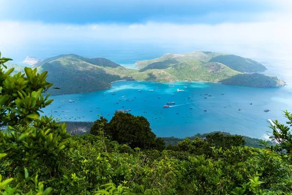 stock image view of Ben Dam Port in Con Dao island, Vietnam with beautiful blue sea blue, sky mountain and colorful boats. Travel and landscape concept.