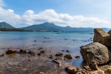 Vietnam 'da barış dolu bir Con Dao adası Vietnam' ın cennet adasıdır. Dalgalı kıyı manzarası, kıyı şeridi, açık gökyüzü ve yol, mavi deniz, turistler ve dağ. Seyahat ve manzara konsepti.