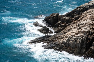 Dalgalar sahildeki kayaları vurur, deniz suyu gökyüzüne güneş ile vurur. Vietnam 'da barış dolu bir Con Dao adası Vietnam' ın cennet adasıdır. Seyahat ve manzara konsepti.
