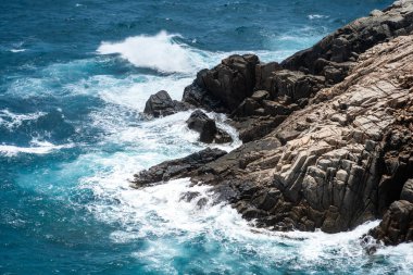 Dalgalar sahildeki kayaları vurur, deniz suyu gökyüzüne güneş ile vurur. Vietnam 'da barış dolu bir Con Dao adası Vietnam' ın cennet adasıdır. Seyahat ve manzara konsepti.