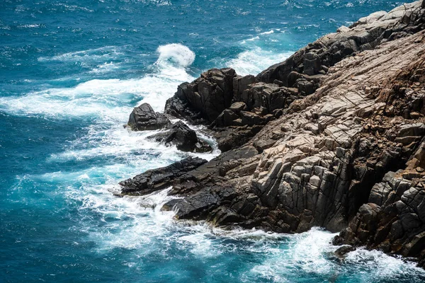 stock image waves hit the rock at beach, sea water splash up to the sky with sun. A peaceful Con Dao island, Vietnam is a Vietnamese island heaven. Travel and landscape concept.