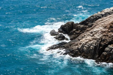 Dalgalar sahildeki kayaları vurur, deniz suyu gökyüzüne güneş ile vurur. Vietnam 'da barış dolu bir Con Dao adası Vietnam' ın cennet adasıdır. Seyahat ve manzara konsepti.
