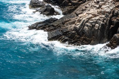 Dalgalar sahildeki kayaları vurur, deniz suyu gökyüzüne güneş ile vurur. Vietnam 'da barış dolu bir Con Dao adası Vietnam' ın cennet adasıdır. Seyahat ve manzara konsepti.