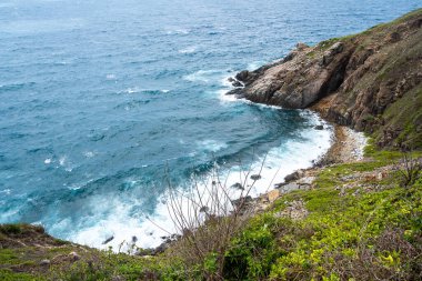Dalgalar sahildeki kayaları vurur, deniz suyu gökyüzüne güneş ile vurur. Vietnam 'da barış dolu bir Con Dao adası Vietnam' ın cennet adasıdır. Seyahat ve manzara konsepti.