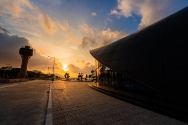 Con Son kasabasındaki yeni Con Dao yolcu limanının manzarası. Huzurlu bir Con Dao Adası, Vietnam. Dalgalı kıyı manzarası, kıyı şeridi, açık gökyüzü, mavi deniz, turistler ve dağ. Seyahat ve manzara konsepti.