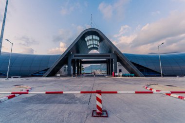 Con Son kasabasındaki yeni Con Dao yolcu limanının manzarası. Huzurlu bir Con Dao Adası, Vietnam. Dalgalı kıyı manzarası, kıyı şeridi, açık gökyüzü, mavi deniz, turistler ve dağ. Seyahat ve manzara konsepti.