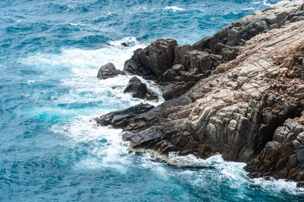 Dalgalar sahildeki kayaları vurur, deniz suyu gökyüzüne güneş ile vurur. Vietnam 'da barış dolu bir Con Dao adası Vietnam' ın cennet adasıdır. Seyahat ve manzara konsepti.