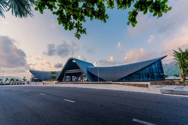 stock image View of new Con Dao passenger port in Con Son town, a peaceful Con Dao island, Vietnam. Coastal view with waves, coastline, clear sky, blue sea, tourists and mountain. Travel and landscape concept.