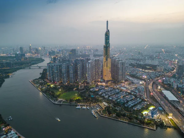 stock image Aerial view of a Ho Chi Minh City, Vietnam with development buildings, transportation, energy power infrastructure. Financial and business centers. Sunset to night. Travel and landscape concept.