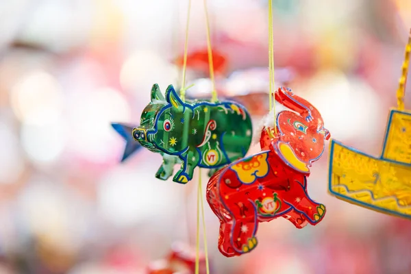 stock image Decorated colorful lanterns hanging on a stand in the streets in Ho Chi Minh City, Vietnam during Mid Autumn Festival. Chinese language in photos mean money and happiness. Selective focus.