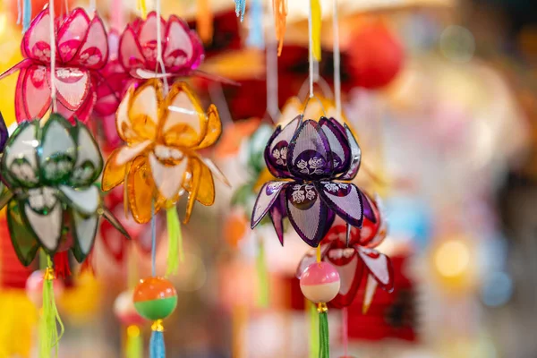 stock image Decorated colorful lanterns hanging on a stand in the streets in Ho Chi Minh City, Vietnam during Mid Autumn Festival. Chinese language in photos mean money and happiness. Selective focus.