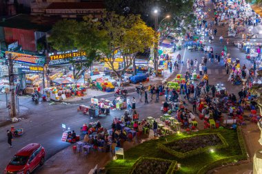 Dalat City, Vietnam - 01 Aralık 2023: Da Lat pazarında gece trafiği. Kalabalık atmosfer, soğuk havada sokak yemekleriyle beslenen gezginler, pazar yerinde kalabalık.