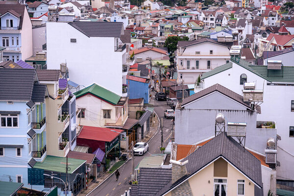 Dalat city, Vietnam - 02 Dec 2023: View on roofs in the city of Dalat. Da Lat and the surrounding area is a popular tourist destination of Asia. City with fogs and mountains