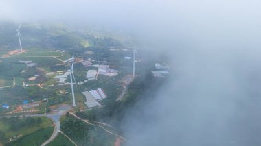 Sabahleyin, Da Lat şehri, Cau Dat, Lam Dong 'da güzel bir manzara. Çay tepesinde rüzgar enerjisi, çayın yamacında sabah manzarası güzel vadinin altındaki sisli dağlarda ekilmiş.